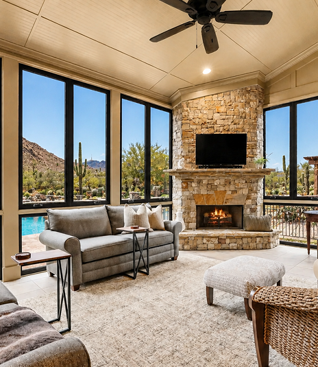 Living room with stone fireplace and desert view