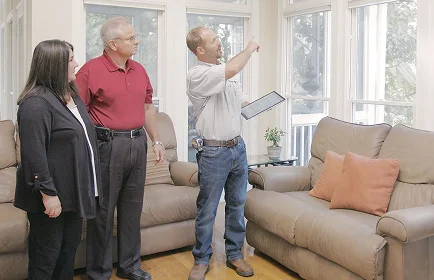 Consultant assessing current windows and doors with homeowners